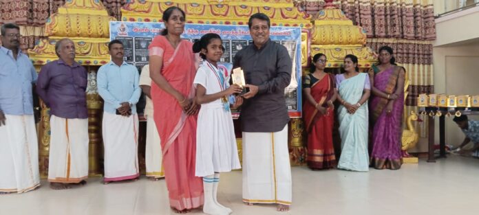 Professor S. Raguram and guests distributing educational kits to students at Michael Nesakkaram's 8th anniversary in Jaffna.
