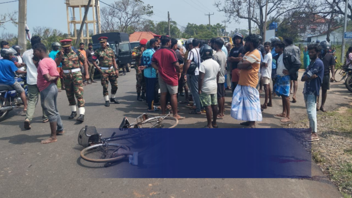 Police investigating the site of a fatal accident in Myliddy, Jaffna involving an army vehicle and a cyclist.